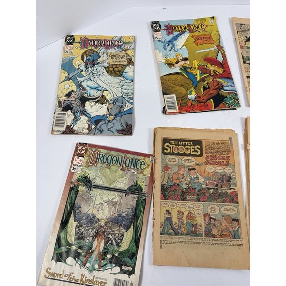 Lot 862 | COLLECTION OF AMERICAN DC DRAGONLANCE COMICS BOOKS Vintage Comic Lot Dragonlance DC + Comic Pages Porky Pig Stooges Rough Condition